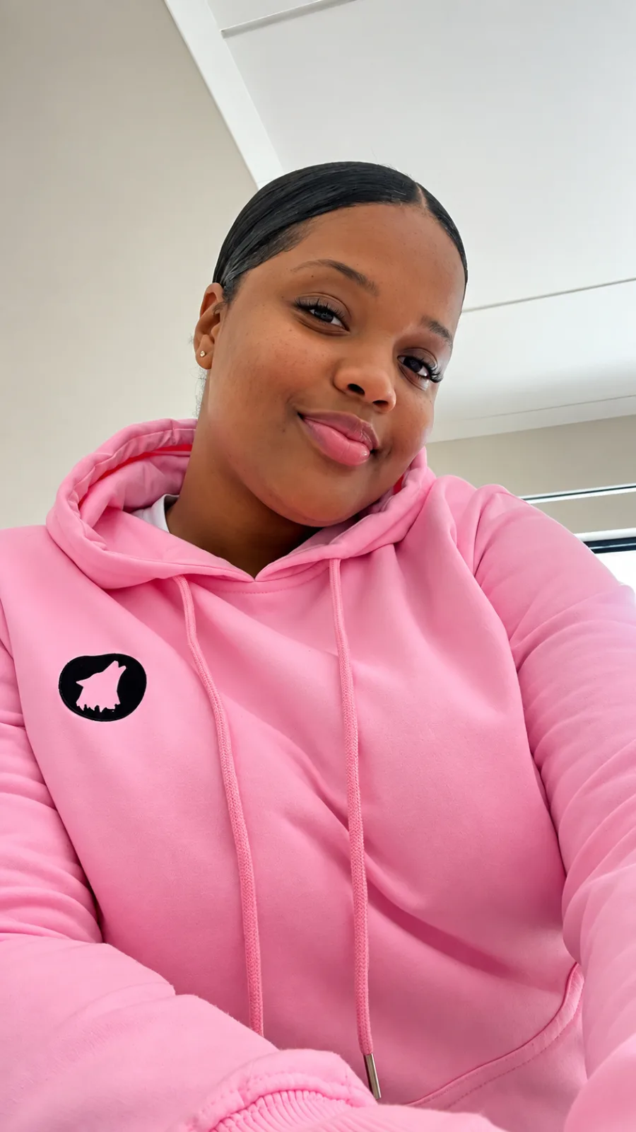 Model wearing a pink Wolf Head hoodie
