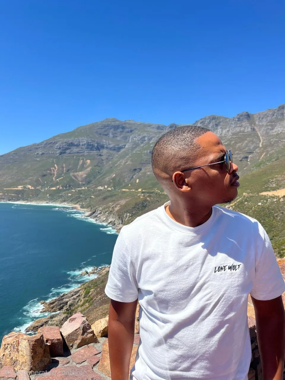 Model wearing a white Lone Wolf typography T-shirt outdoors